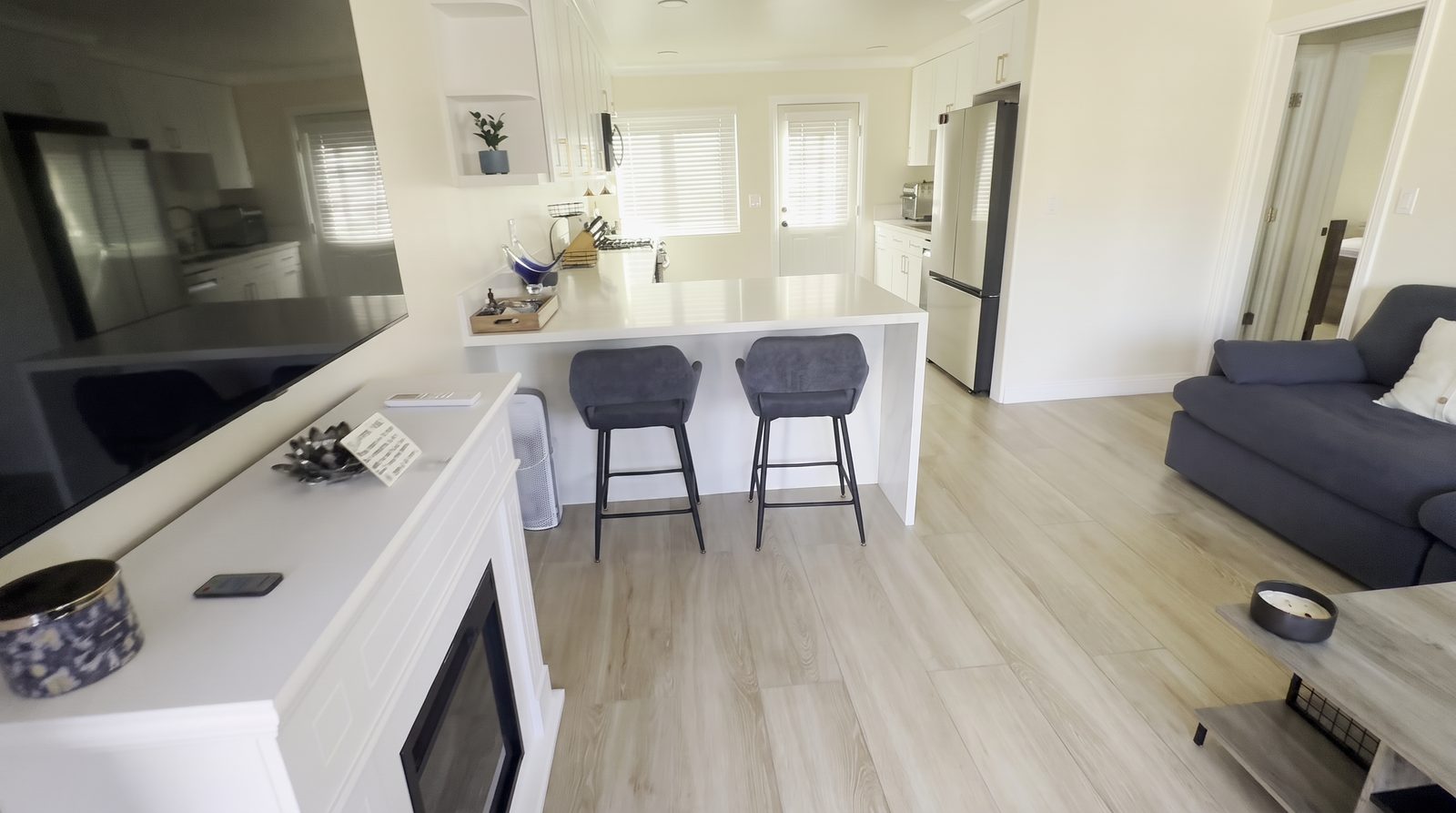 Kitchen with quartz island and seating at Her Aria women's recovery residence serving Los Angeles and San Bernardino Counties